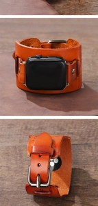 Detail of vintage brown leather cuff watch band with metal buckle and rivet accents