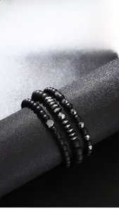 Close-up of matte black agate and silver hematite beaded bracelets in a 3-piece set