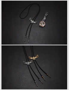 Macro shot of vintage metal eagle bolo tie with braided black leather neck rope