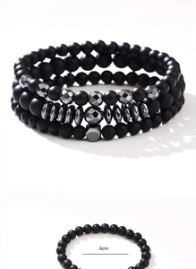 Close-up of three-piece men's bracelet set with black matte beads and 6cm diameter detail