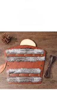 Detail view of 21.5cm Viking leather bracer with rabbit fur and bronze rivet accents