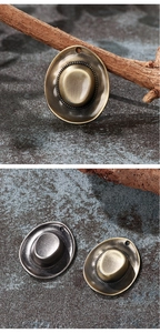 Detail of vintage cowboy hat pendants in antique bronze and silver for DIY jewelry