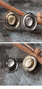 Detailed macro view of vintage bronze and silver cowboy hat alloy charms with weave texture