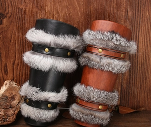 Detail of Viking faux leather arm guards with grey rabbit fur trim and metal rivets