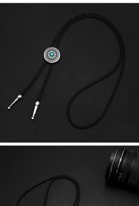 Detail of vintage Western bolo tie featuring silver floral engraving and turquoise stone