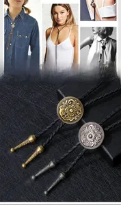 Detail of vintage bolo tie showing embossed flower pattern on bronze metal slide with cord