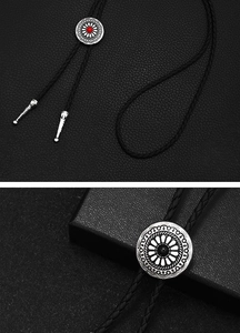 Detail of vintage silver bolo tie with turquoise stones and braided black leather cord
