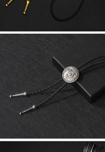 Detailed macro of vintage silver floral engraved bolo tie buckle and braided leather cord