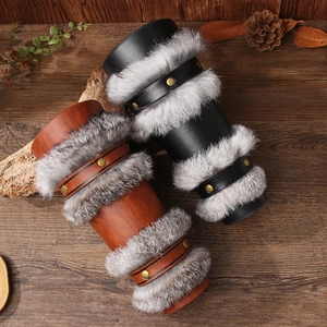 Viking faux leather bracers with faux fur trim in black and brown on wooden background