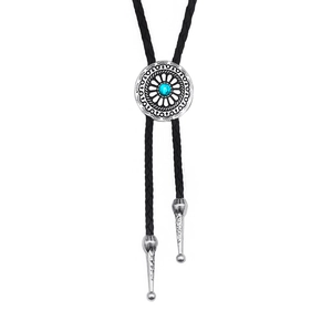 Vintage silver bolo tie with turquoise stone and ornate engraved metal floral accents