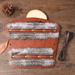 Viking faux leather bracers with rabbit fur trim on a rustic wooden background
