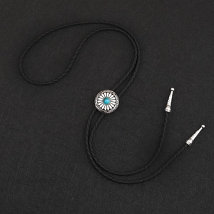 Retro bolo tie with turquoise centerpiece and engraved silver sunflower pendant