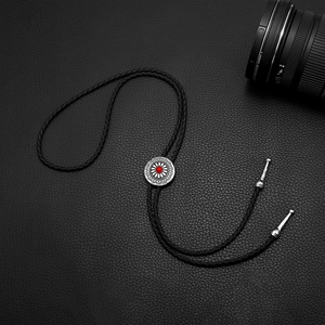 Vintage Bolo Tie featuring sunflower metal pendant with red stone on black leather cord