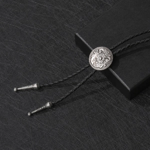 Vintage silver flower bolo tie with black braided leather cord and metal aglets