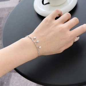 Detail of S925 sterling silver bracelet with clover pendant and sparkling round stones