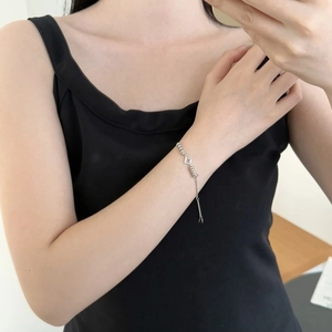 Close-up of S925 silver four-leaf clover bracelet worn on wrist with adjustable chain