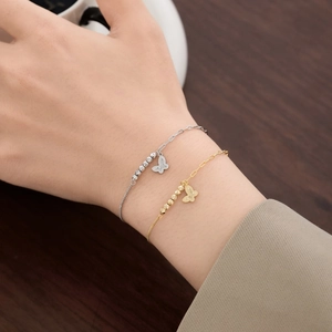 S925 sterling silver butterfly charm bracelet featuring metallic beads on a delicate chain