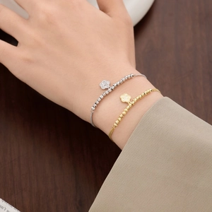 Elegant S925 sterling silver beaded bracelet with a four-leaf clover pendant on a wrist