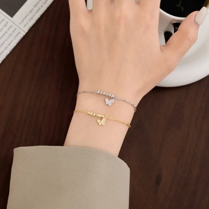 Close-up of S925 silver double butterfly pendant bracelet set with lucky beads