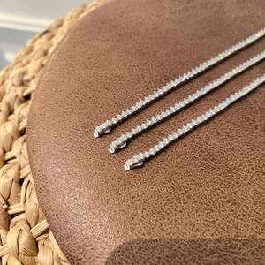 Macro detail of three silver S925 sterling silver tennis bracelets with 3mm cubic zirconia