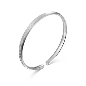Elegant S925 sterling silver open bangle featuring textured wave patterns and polished finish