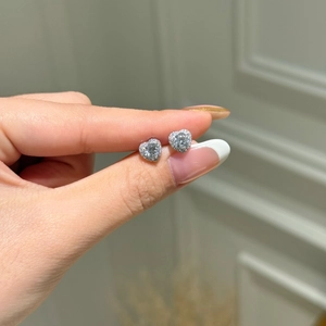 Detailed view of heart-shaped S925 sterling silver stud earrings with sparkling zircons