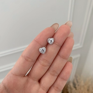 Close-up of S925 sterling silver heart-shaped stud earrings with sparkling cubic zirconia