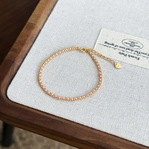 Close-up of S925 silver beaded bracelet with pink charms and heart-shaped pendant detail