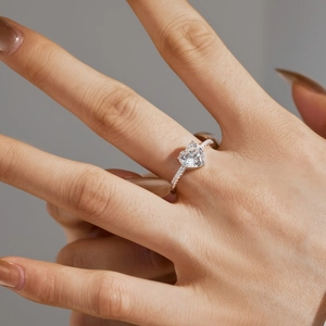 Close-up of a 2-carat heart-shaped moissanite ring in S925 silver on a model hand