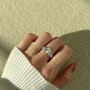 Detailed close-up of S925 sterling silver ring with sparkling round moissanite in prong setting