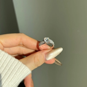 Close-up of S925 silver engagement ring with oval 2ct moissanite stone and pavé setting