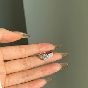Macro view of oval cut moissanite ring with multi-row pave setting on silver band