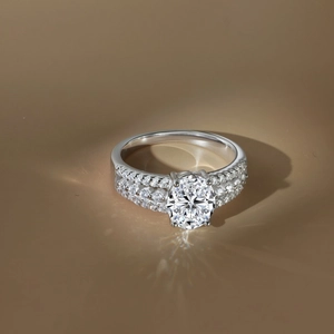 Macro shot of oval Moissanite ring with triple row pavé diamonds on the band