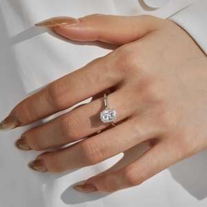 Macro detail of oval cut moissanite ring showing 4-prong setting on silver band