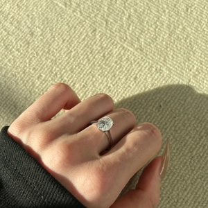 Macro shot of 3-carat oval moissanite ring in S925 sterling silver on model hand