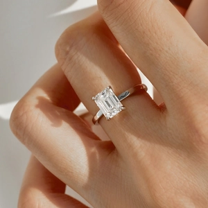 Close-up of 2 carat emerald cut moissanite engagement ring in S925 silver on hand