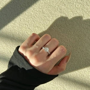 Close-up of S925 sterling silver twist ring with a 2-carat moissanite stone on hand