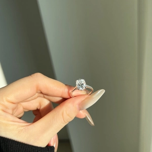 Detail of an oval cut 3ct moissanite ring with a four-prong sterling silver setting