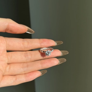 Macro detail of 2 carat moissanite ring with six-prong setting and side diamonds