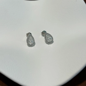 Close-up of elegant S925 silver pear-shaped halo stud earrings with sparkling moissanite