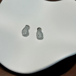 Close-up of teardrop halo stud earrings featuring moissanite stones in S925 silver