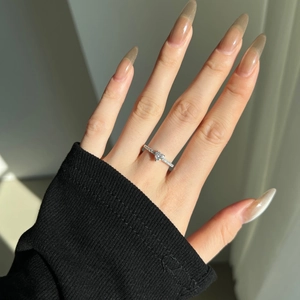Close-up of S925 silver heart-shaped moissanite ring worn on a finger with elegant lighting