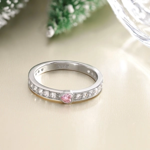 Gros plan d'une bague en argent S925 avec une pierre cœur rose et petits diamants