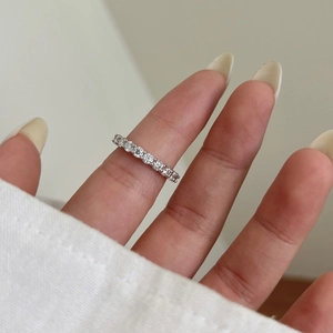 Sparkling S925 sterling silver moissanite row ring displayed on a woman's finger