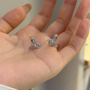 Détail des boucles d'oreilles nœud en argent avec pierres de moissanite rondes et brillantes