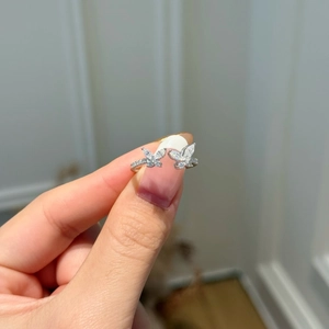 Detailed close-up of a silver open ring featuring sparkling marquise butterfly cubic zirconia