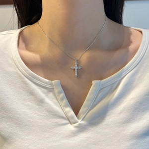 S925 sterling silver cross pendant necklace with sparkling moissanite on a model