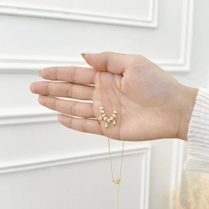 Close-up of S925 silver necklace featuring water drop pendants and matte gold beads