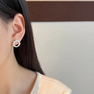 Close-up of S925 sterling silver hollow round stud earrings with pave set moissanite stones