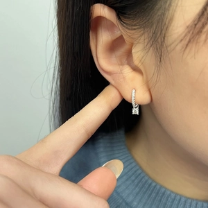 Close-up of S925 sterling silver hoop earrings with square moissanite pendant on ear